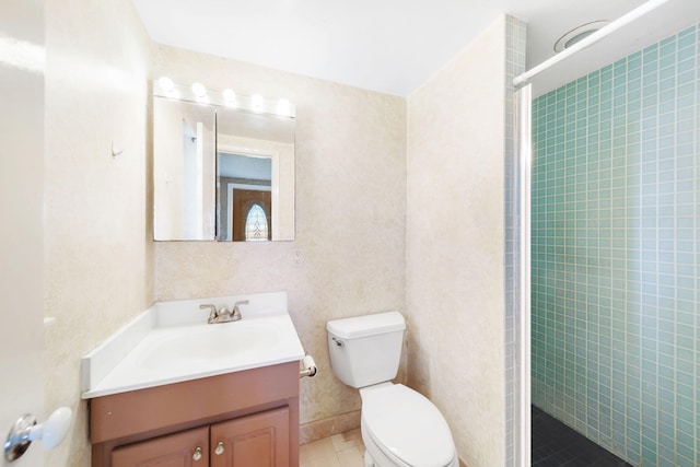 bathroom with tile patterned floors, vanity, toilet, and an enclosed shower