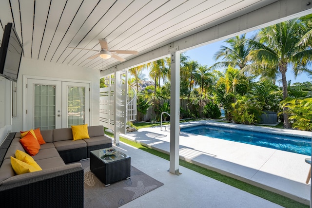 view of pool featuring an outdoor living space, a patio, and ceiling fan