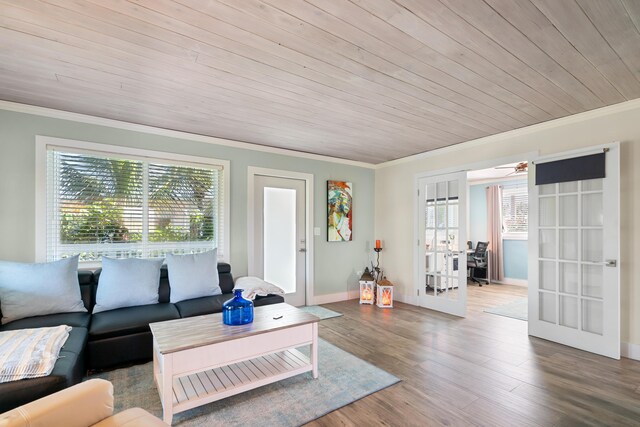 living room featuring french doors, wood ceiling, ornamental molding, and wood-type flooring