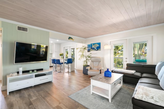 living room with crown molding, dark hardwood / wood-style floors, wooden ceiling, and french doors