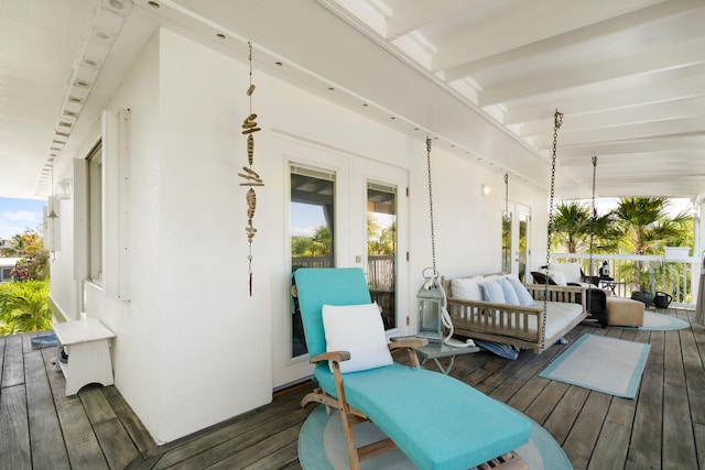 wooden terrace with an outdoor hangout area