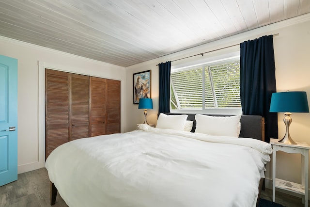 bedroom with hardwood / wood-style flooring, wooden ceiling, and a closet