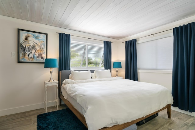 bedroom with hardwood / wood-style flooring and wooden ceiling