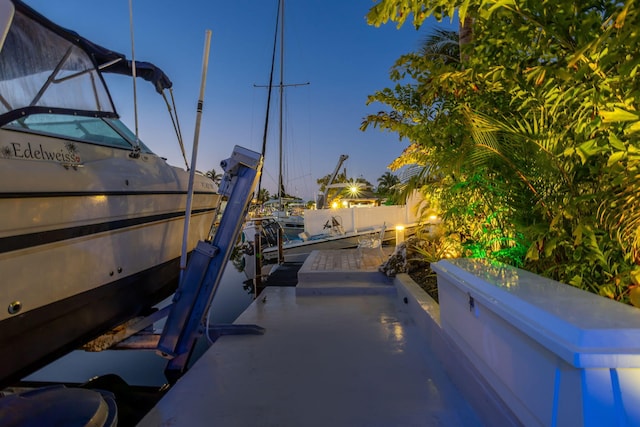 patio terrace at dusk featuring a boat dock