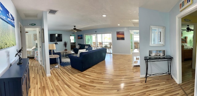 living room with ceiling fan and light hardwood / wood-style floors