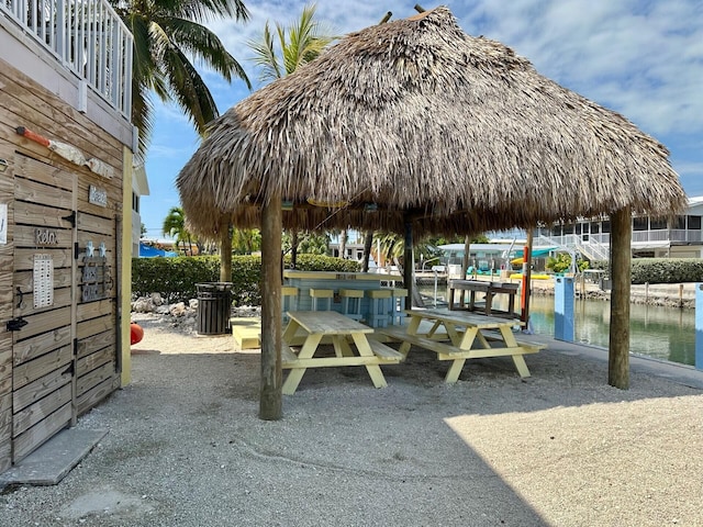 exterior space featuring a gazebo and a water view