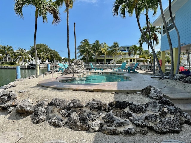 view of pool featuring a water view