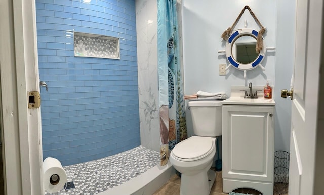 bathroom featuring vanity, a shower with shower curtain, and toilet