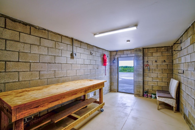 interior space with concrete block wall and concrete floors