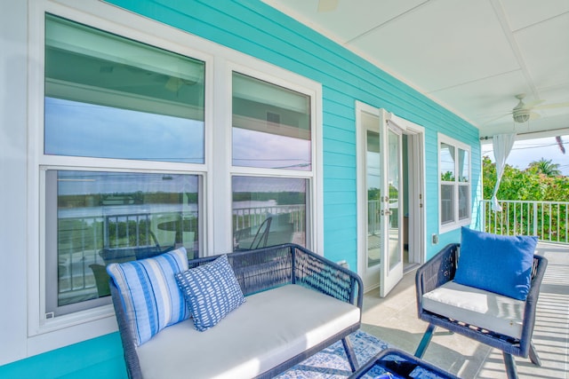 balcony with a ceiling fan and french doors