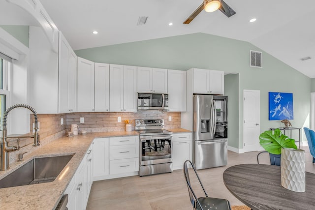 kitchen featuring appliances with stainless steel finishes, a sink, visible vents, and white cabinets