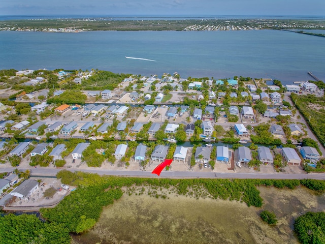 drone / aerial view with a water view and a residential view