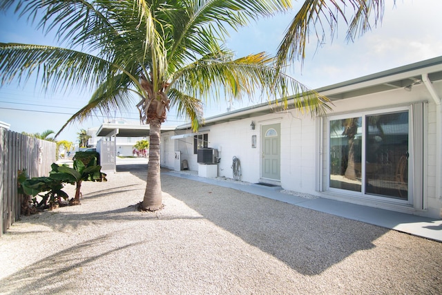 view of front of property featuring a carport and central AC