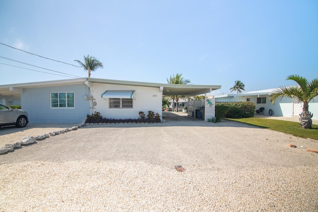 ranch-style house featuring a carport