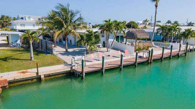 dock area featuring a yard and a water view