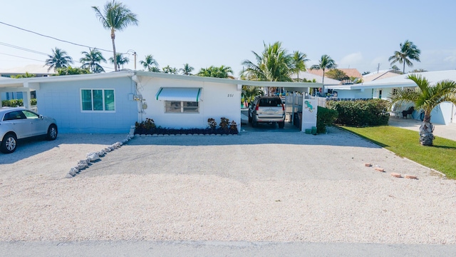 single story home featuring a carport