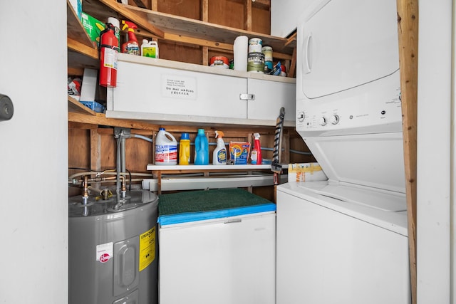 laundry area with stacked washer and clothes dryer and electric water heater