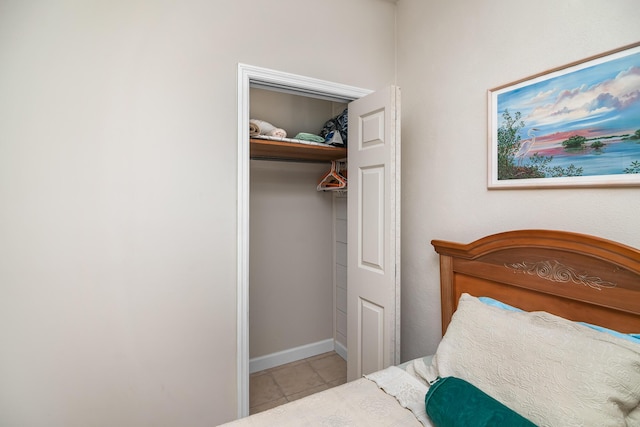 tiled bedroom with a closet