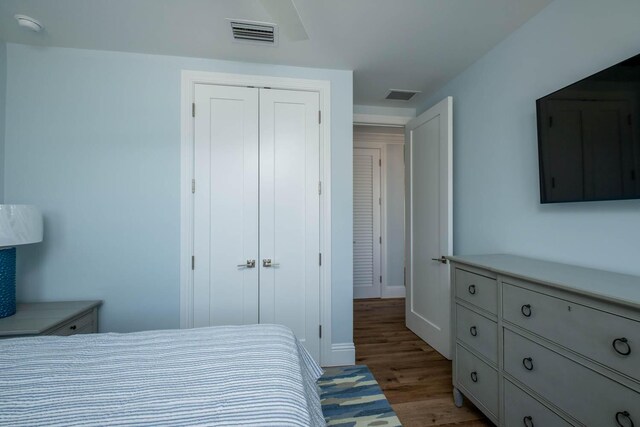 bedroom featuring a closet, baseboards, visible vents, and light wood finished floors