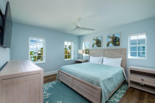 bedroom featuring baseboards, ceiling fan, and wood finished floors