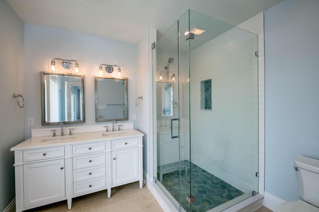 bathroom with a stall shower, toilet, and a sink