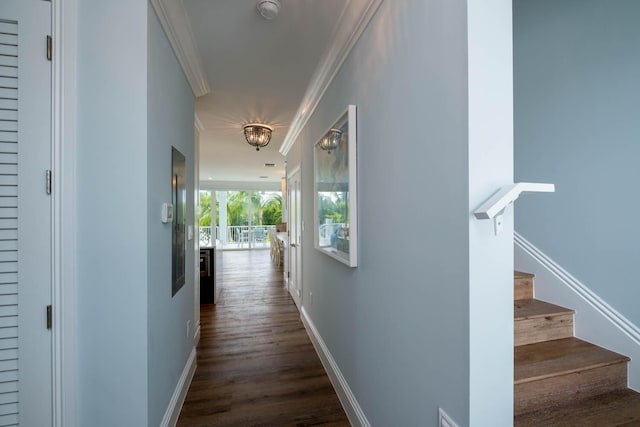corridor with crown molding, stairway, a chandelier, and baseboards