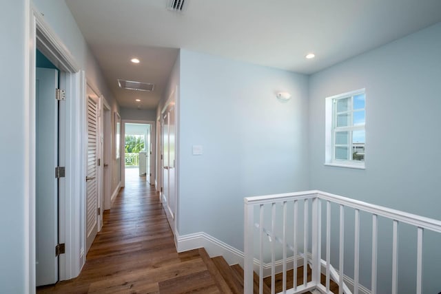 corridor featuring visible vents, an upstairs landing, wood finished floors, and recessed lighting