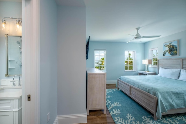bedroom with a sink, baseboards, ceiling fan, and wood finished floors