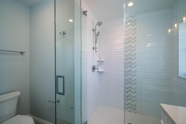 bathroom with a stall shower and toilet