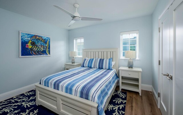 bedroom with baseboards, dark wood-style floors, and a ceiling fan