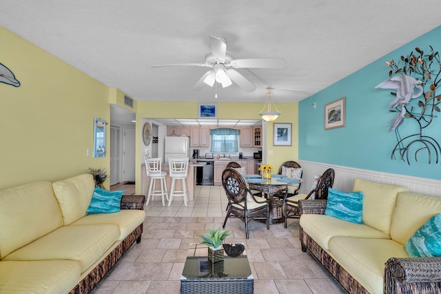 200 Wrenn St Unit 509, Tavernier, FL 33070 - living area with ceiling fan, wainscoting, and stone tile floors
