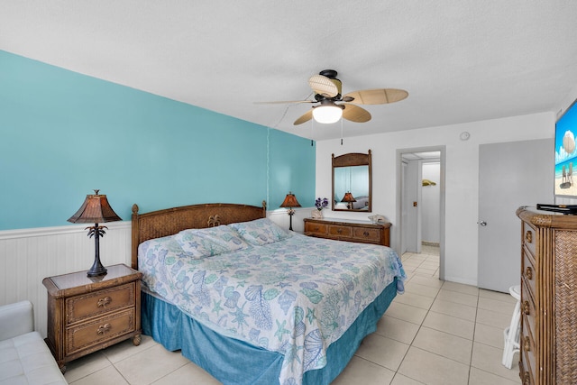 200 Wrenn St Unit 509, Tavernier, FL 33070 - bedroom featuring light tile patterned floors, ceiling fan, and a wainscoted wall