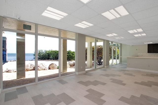 200 Wrenn St Unit 509, Tavernier, FL 33070 - spare room with floor to ceiling windows, view of water and beach, and a drop ceiling
