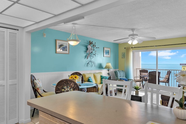 200 Wrenn St Unit 509, Tavernier, FL 33070 - dining area with ceiling fan, wainscoting, and a water view