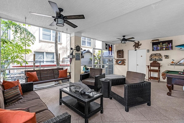 17 N Dr, Key Largo, FL 33037 - living room with a textured ceiling, ceiling fan, billiards, and baseboards