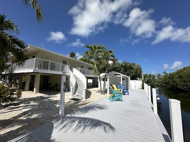 view of dock with a deck with water view