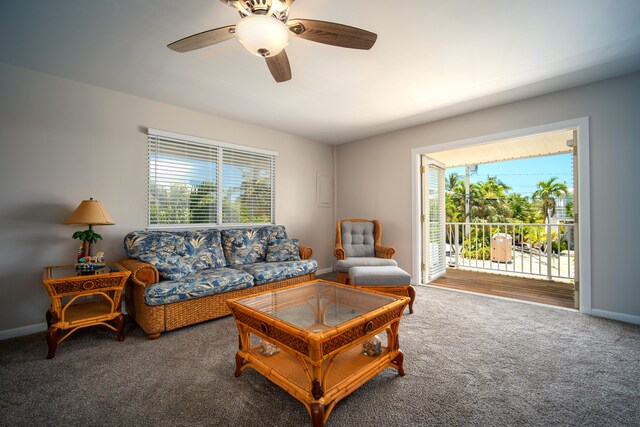 living room featuring ceiling fan and carpet