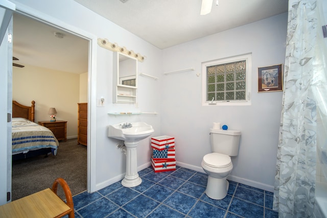 bathroom featuring a shower with curtain, tile patterned flooring, ceiling fan, and toilet