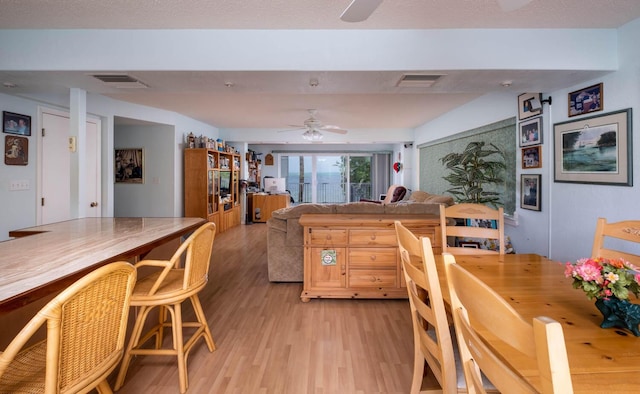 dining room with ceiling fan and light hardwood / wood-style flooring