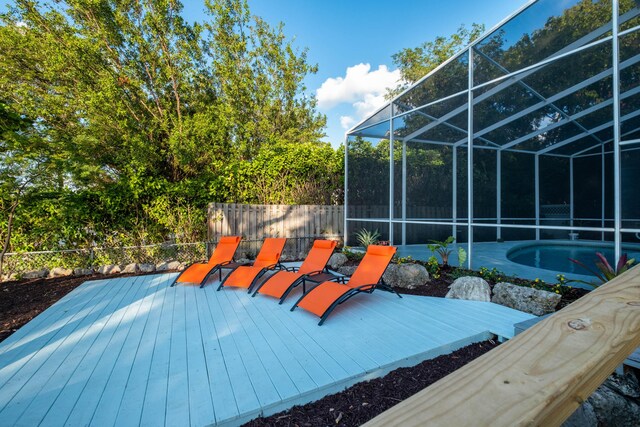 wooden deck featuring a lanai