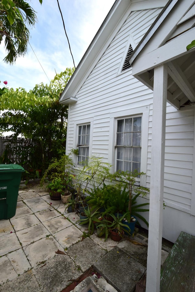 view of side of home featuring a patio and fence