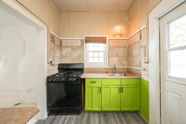 kitchen featuring sink, black range with gas stovetop, and a healthy amount of sunlight