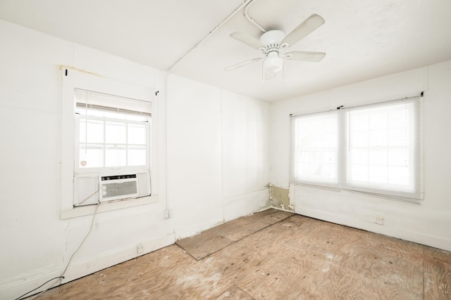 unfurnished room with cooling unit and ceiling fan