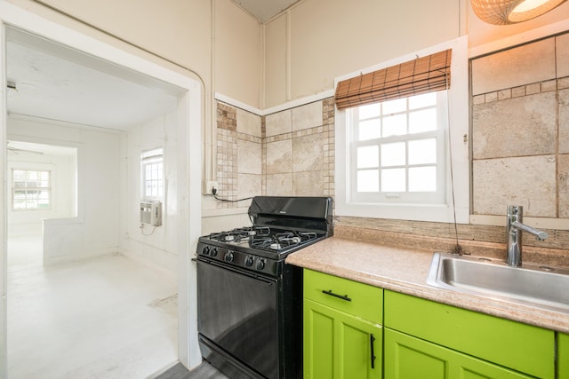 kitchen with green cabinets, black range with gas cooktop, and sink