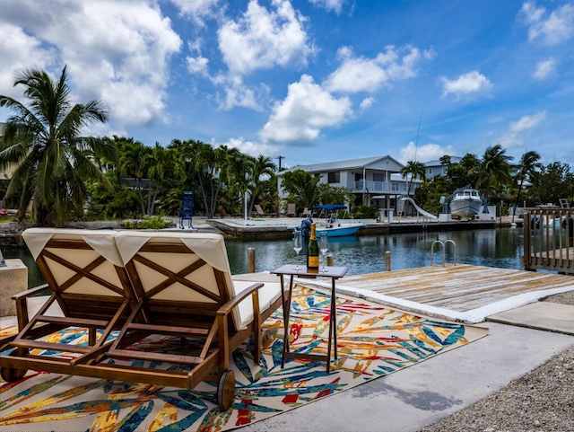 view of swimming pool with a water view and a boat dock