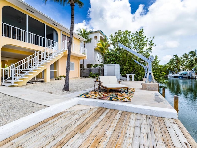 dock area featuring a water view and a patio area