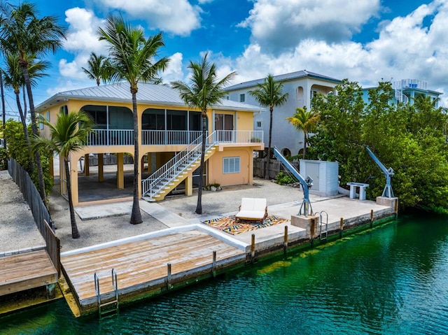 rear view of property featuring a patio and a water view