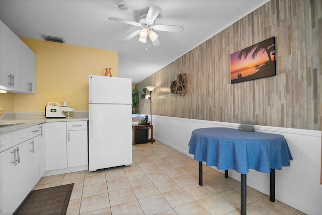 kitchen with visible vents, light countertops, light tile patterned floors, freestanding refrigerator, and a ceiling fan