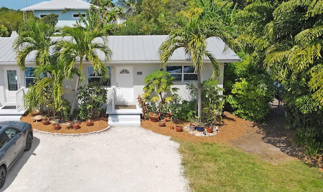 single story home featuring metal roof
