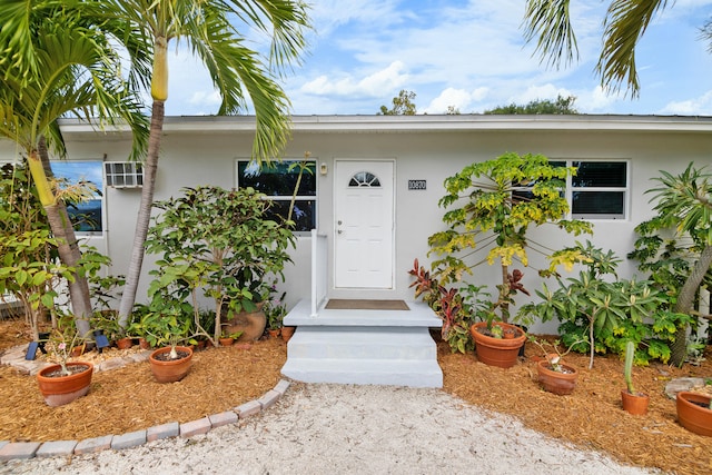 doorway to property with stucco siding